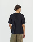Back view of the black Mason Smocked Neck Blouse showing raglan seams and elastic puff sleeve cuffs