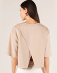 Back view of the taupe Hazel top showing the overlapping split back panels