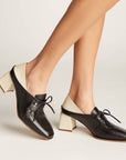 Side view of the Stivali Focus heeled loafer showing the off-white block heel