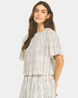 Side view of the Azure Horizon Top showcasing the soft blue and ivory print, relaxed fit, and contemporary cropped design.