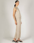Side view of the taupe P.CILL Birdie tank and matching wide-leg pants with black sandals