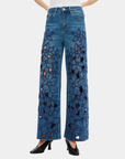 Front view of Bayeas high rise embroidered wide leg jeans in medium blue with floral cutout detailing.