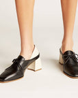 Front three-quarter view of Stivali New York Focus heeled loafers on model