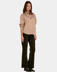 Model wearing the Elan Corey Camel Stripe button down shirt styled with black jeans.