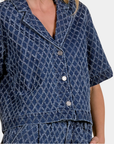 Detail of the Elan Dara Denim Top showing the diamond-pattern denim, wide collar and button front