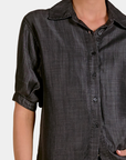 Detail of the Elan Washed Denim Button Down Shirt in Black showing the washed fabric and button front