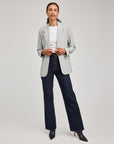 Full-length view of the heather ash Jeanie Blazer styled with a white tee, dark wide-leg jeans and black boots