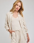 Gentle Fawn Portia striped linen shirt worn open over a cream tank with matching Finley linen pants