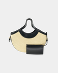 Luna raffia half moon tote with faux leather trim and removable pouch displayed on a neutral background.