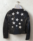 Back view of the Mauritius Christy Black Star Leather Jacket featuring signature silver star appliqués, silver under-collar detail, elbow patches, and distressed lambskin leather.