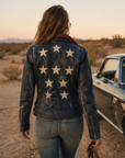 Back view of the Mauritius Christy navy leather jacket showcasing the signature multicolor star appliqué design.
