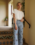 Monaco Pearl Trim Tee in ivory featuring an elegant pearl-trim neckline and relaxed short sleeve silhouette.