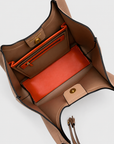 Interior view of the Montemare Sedona Tote in Latte showing the spacious interior, zip pocket, magnetic closure and contrasting orange accents.