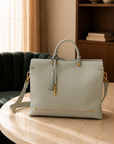 Montemare Vienna Carry-On in Blake’s Blue displayed on a marble table with shoulder strap and gold-tone hardware