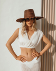 Model wearing the Nalu wide brim straw hat styled for a summer look.
