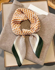 Orange plaid mulberry silk scarf styled around the neck