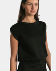 Detail of the P.CILL Kai Butter Modal Mini Dress in Black showing the relaxed bodice and fitted waist