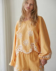 Resort embroidered puff sleeve top front view with detailed embroidery and relaxed fit