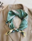 Sea green crane mulberry silk scarf styled around the neck