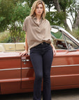 Full-length view of the mocha Pin Stripe Button Down with dark flare jeans and tan sandals
