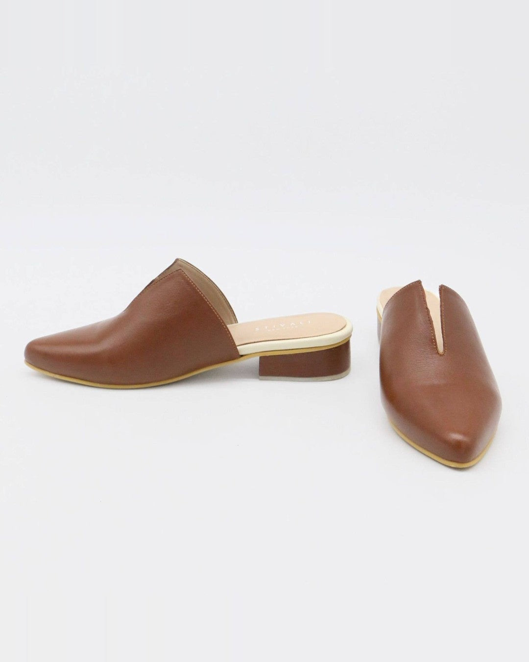 Side and front view of Stivali New York Pijao leather mules showing the low stacked heel