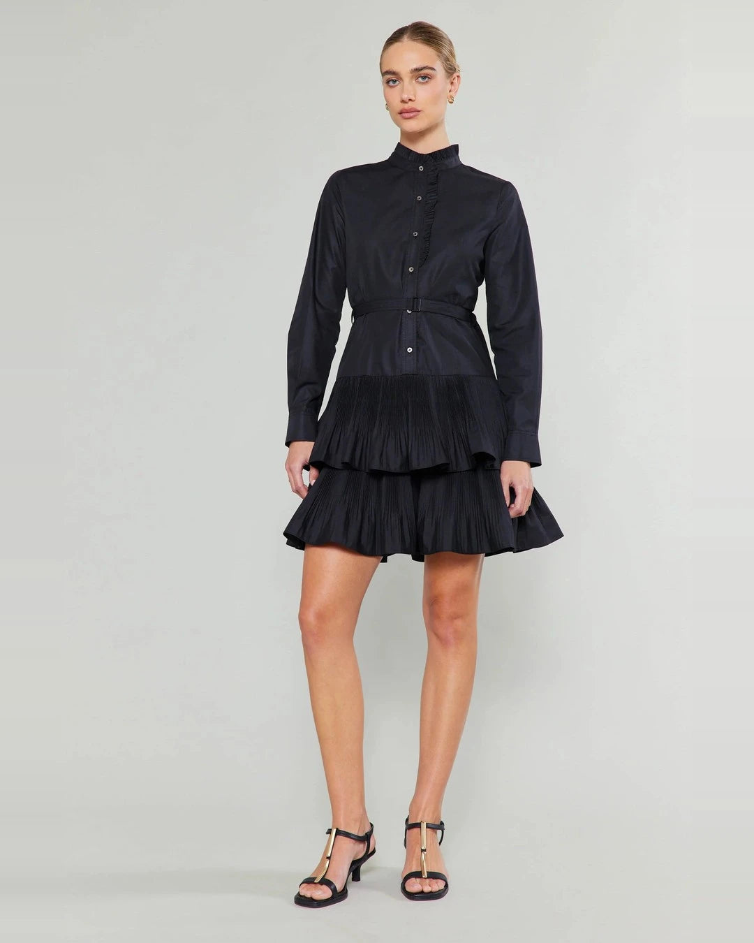 Full-length front view of the black Anberlin Mini Dress worn with black strappy heeled sandals