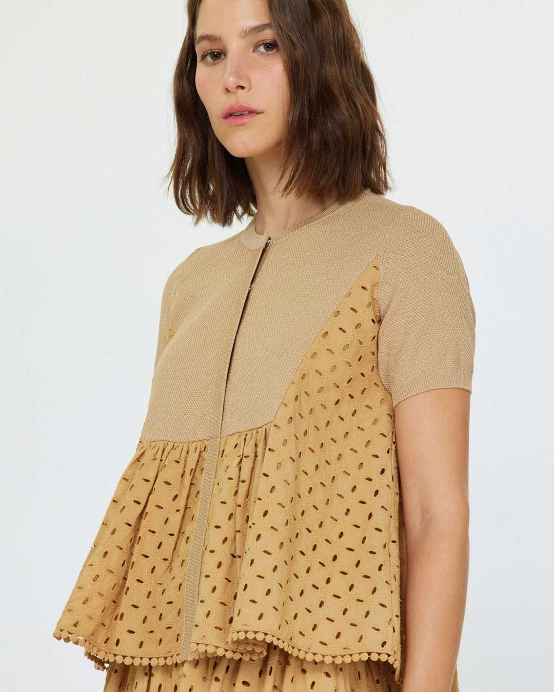 Three-quarter view of the Current Air eyelet blouse showing the gathered peplum and short knit sleeves
