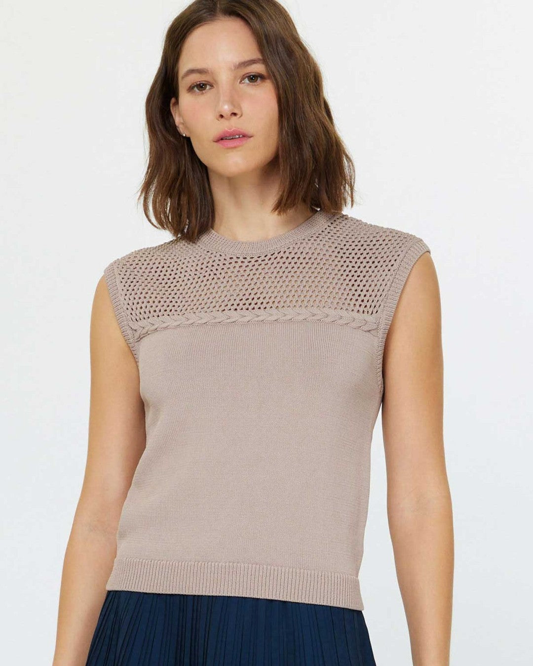 Current Air Stitched Sleeveless Sweater in mocha, front view, with a navy pleated skirt