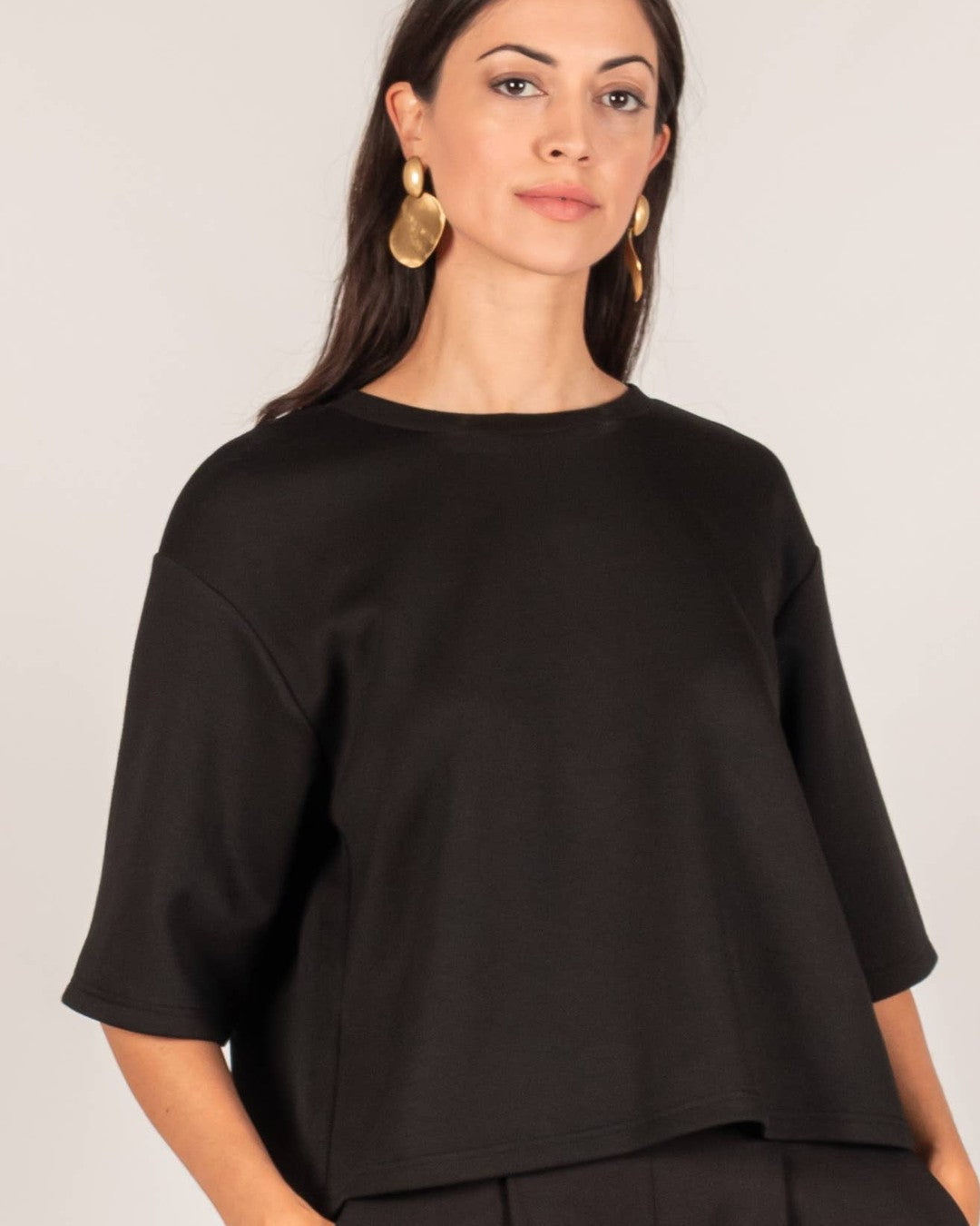 P.CILL Hazel Overlap Back Top in black, front view, worn with black wide-leg pants