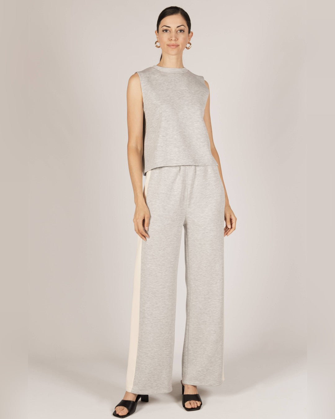 Full-length view of the heather gray Birdie tank with gray wide-leg pants with ivory side stripes
