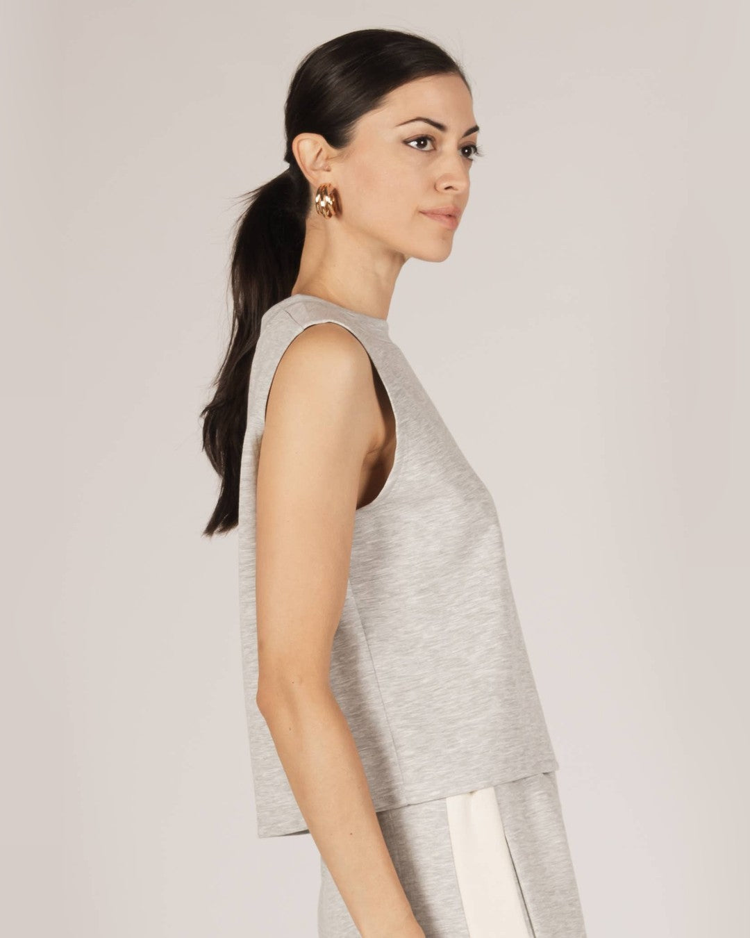 Side profile of the gray P.CILL Birdie Boxy Tank showing the round neck and cut-in armhole