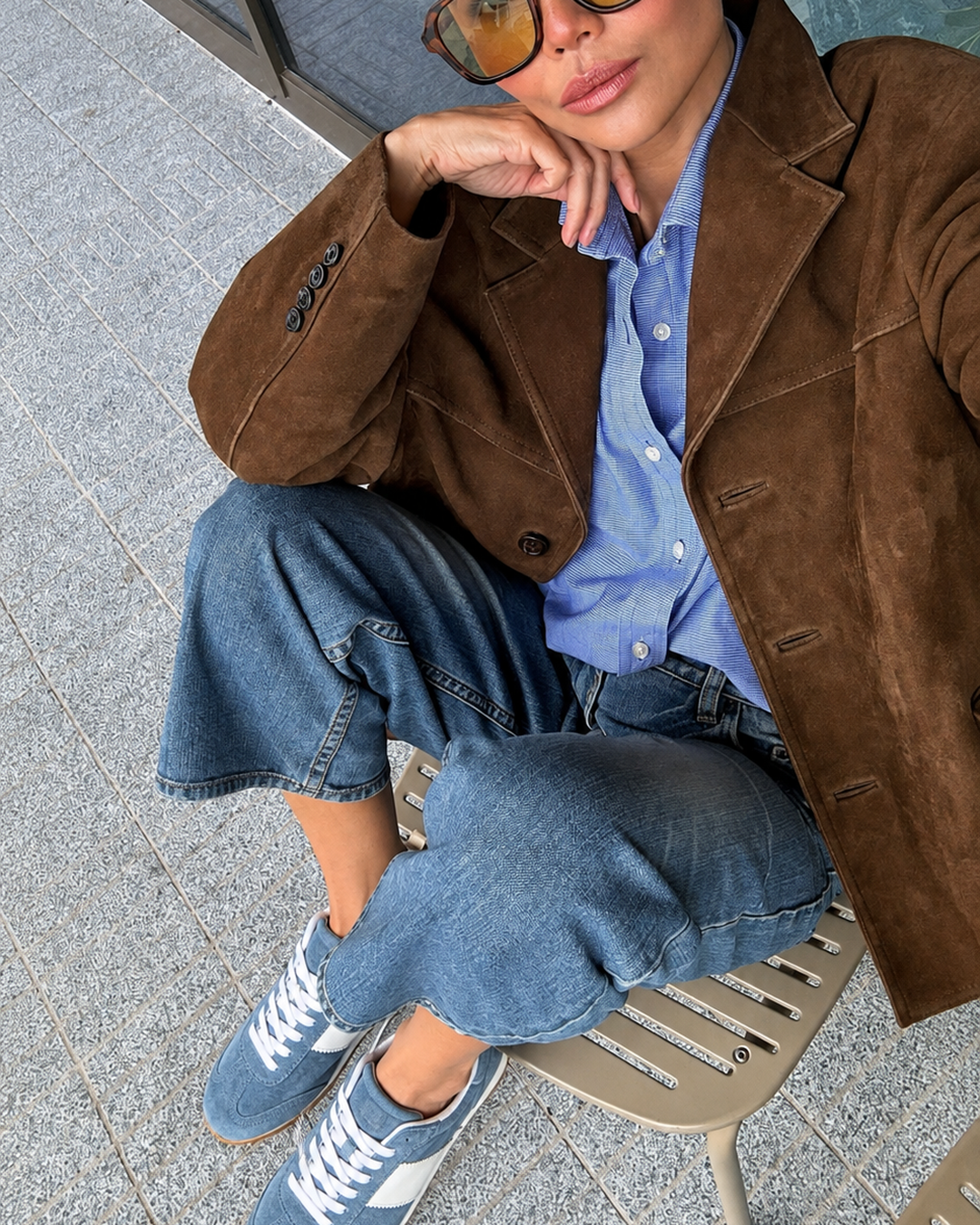 Dolce Vita Shyla blue suede sneakers styled with jeans, a blue shirt and a brown jacket