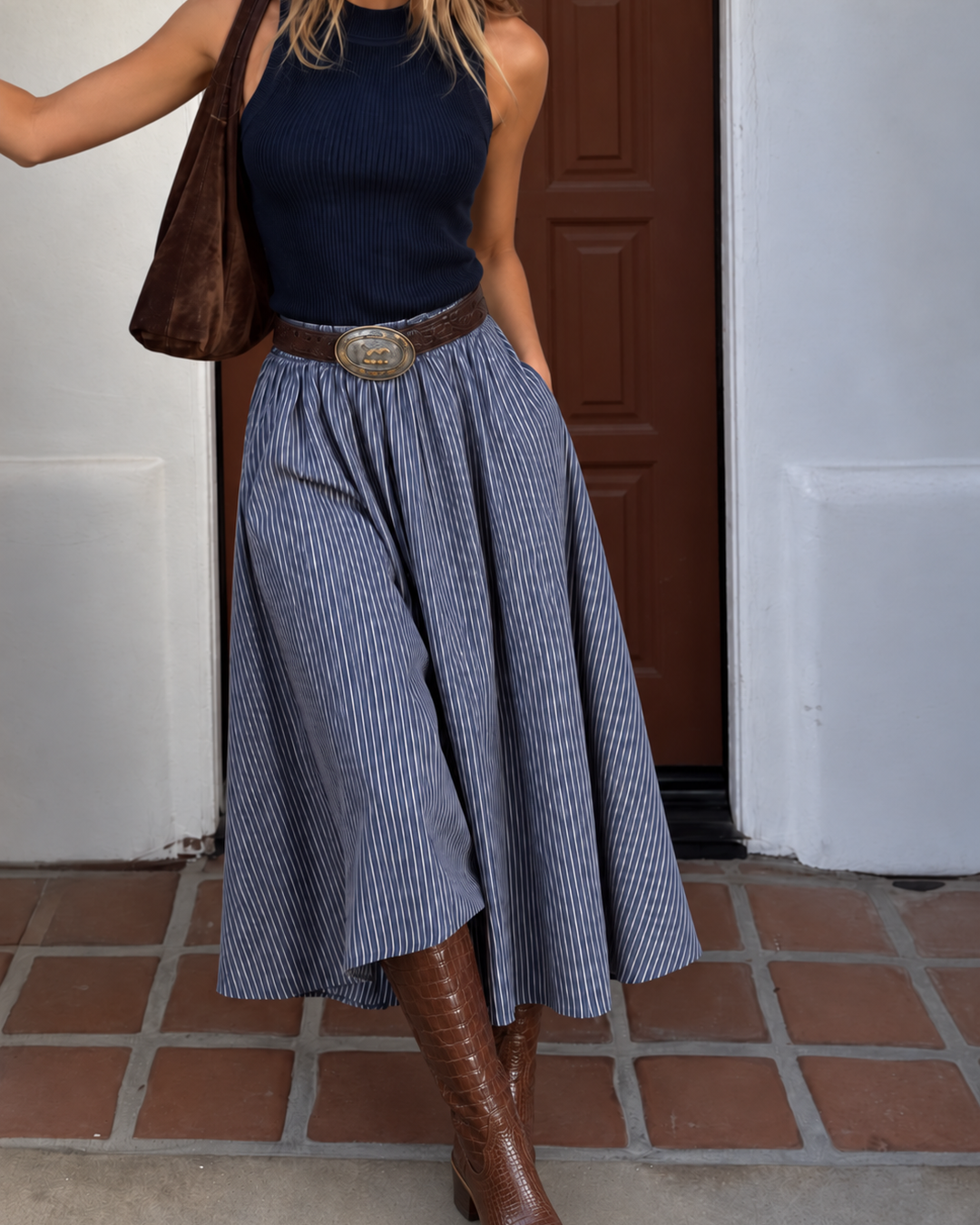 Elan Harlow Mixed Media Midi Dress with navy ribbed tank bodice and blue striped full skirt, worn with a belt, brown suede shoulder bag and brown croc boots