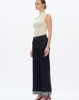 side view of model wearing Bayeas high-rise wide-led Rolle jeans in dark wash