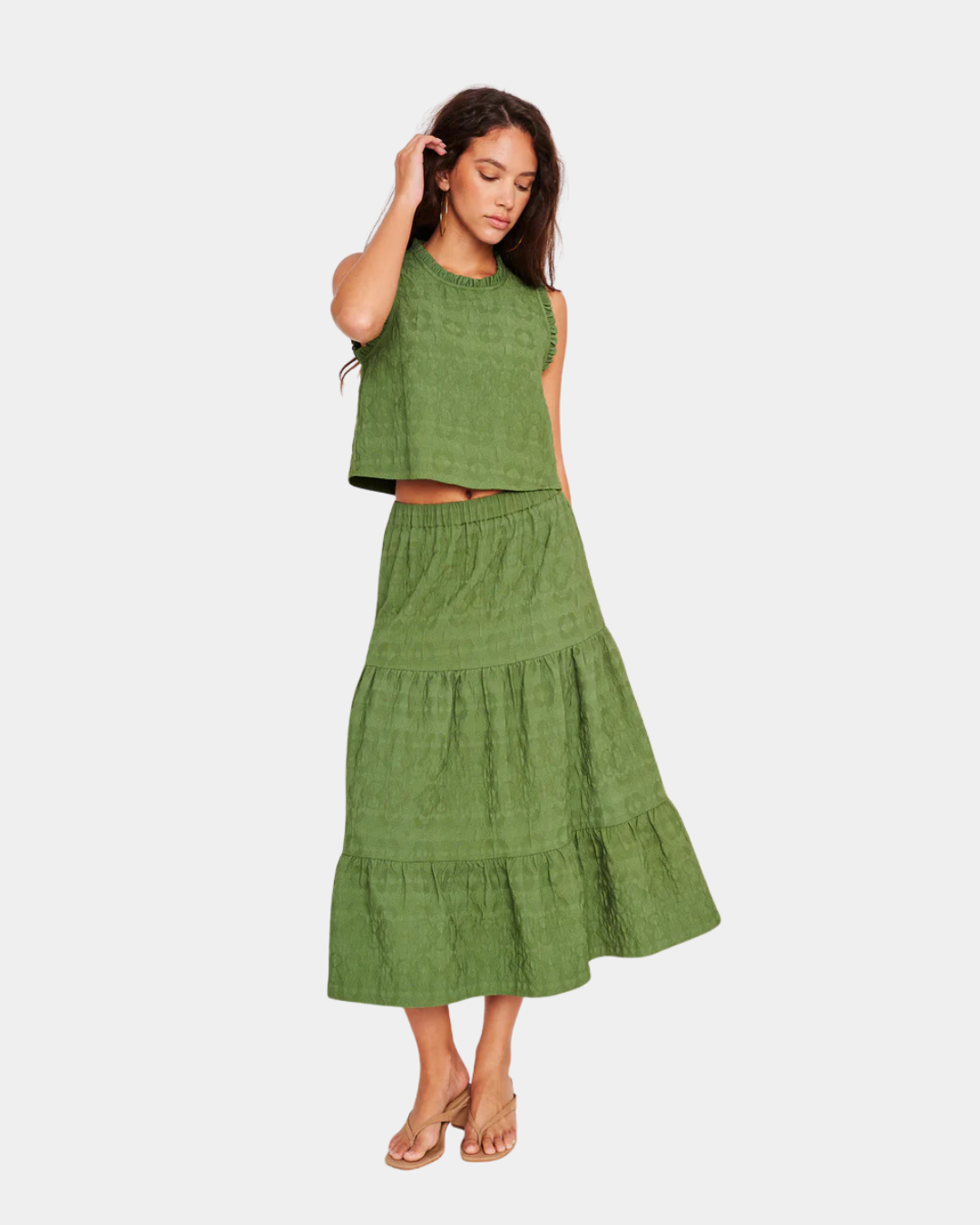 Model wearing D.RA Aviana green textured sleeveless top with subtle ruffle trim and cropped silhouette.