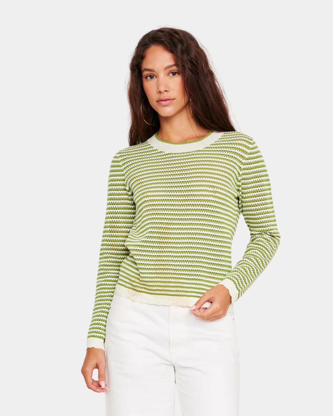 Model wearing D.RA Cori green and ivory striped knit top with long sleeves and fitted silhouette.