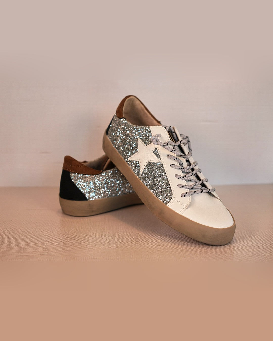 Shushop Paula sneaker showing the silver glitter panel, white star and contrast heel tab