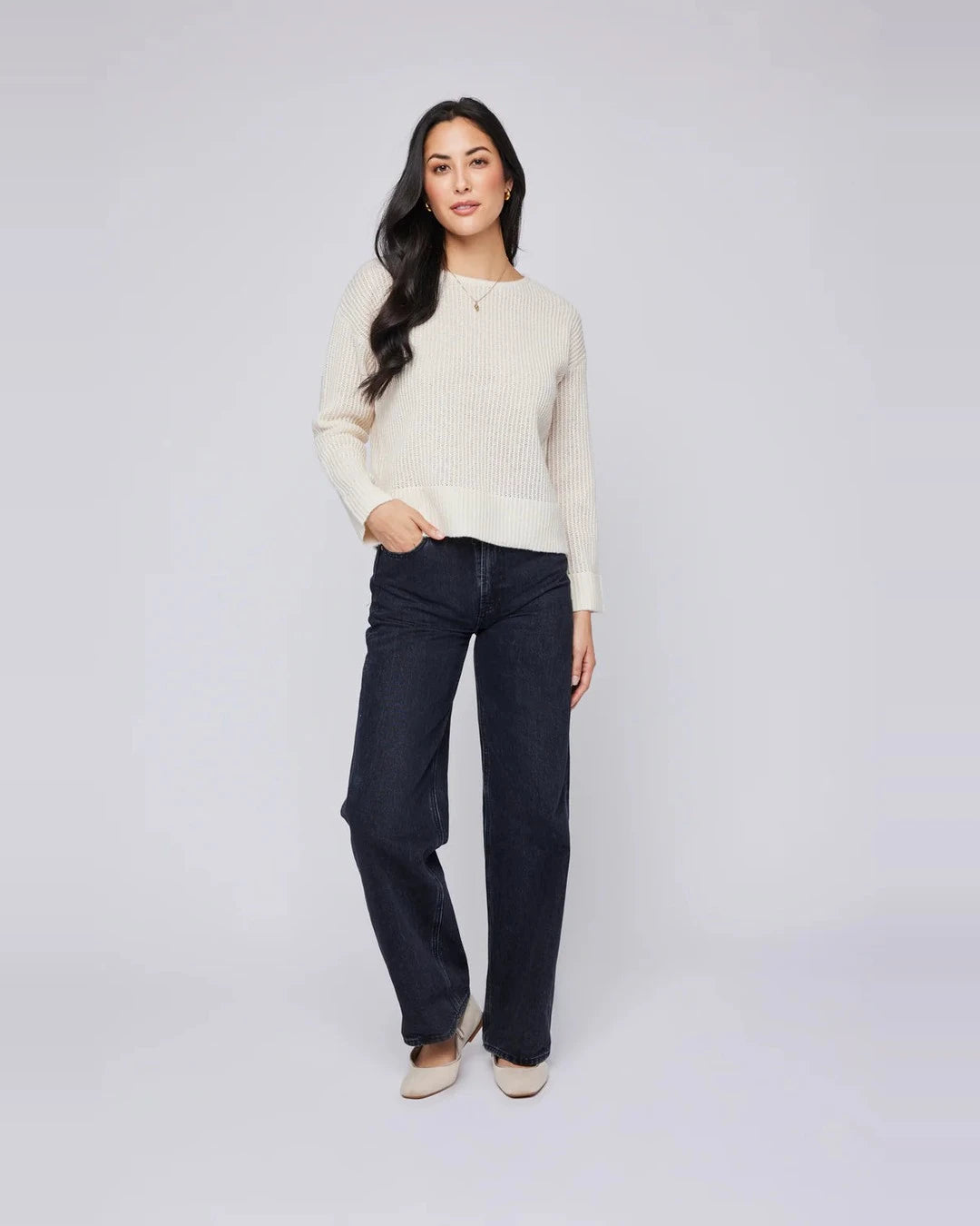 Full-length view of the Gentle Fawn Ambrose sweater in cream styled with dark denim