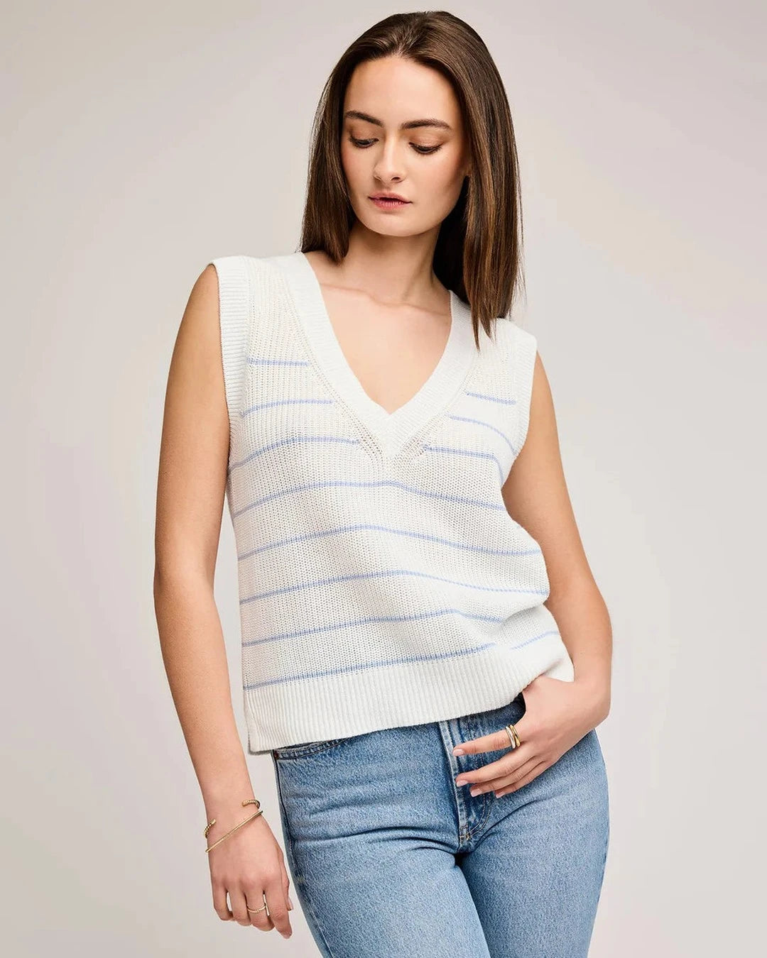 Gentle Fawn Tanner Knit Vest in ivory with blue stripes worn with light-wash jeans, front view