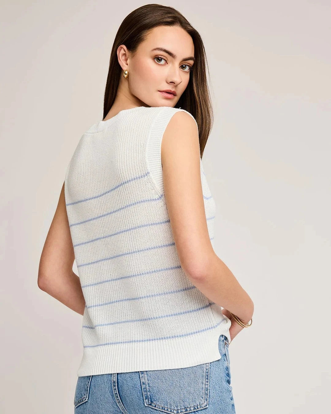 Back view of the blue striped Tanner V-neck knit vest with light jeans