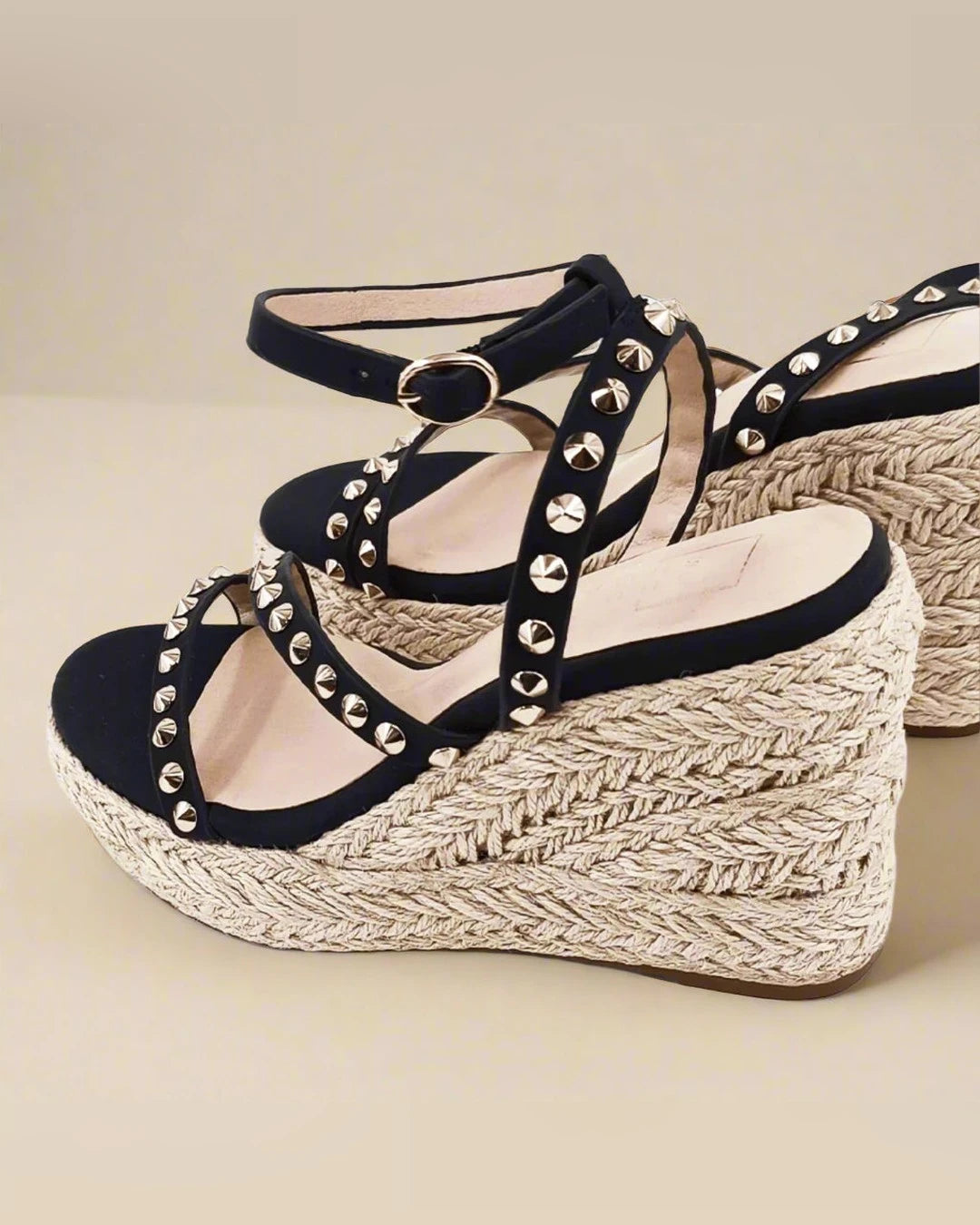 Angled view of the Stella Espadrille Wedge showing studded straps and buckled ankle strap