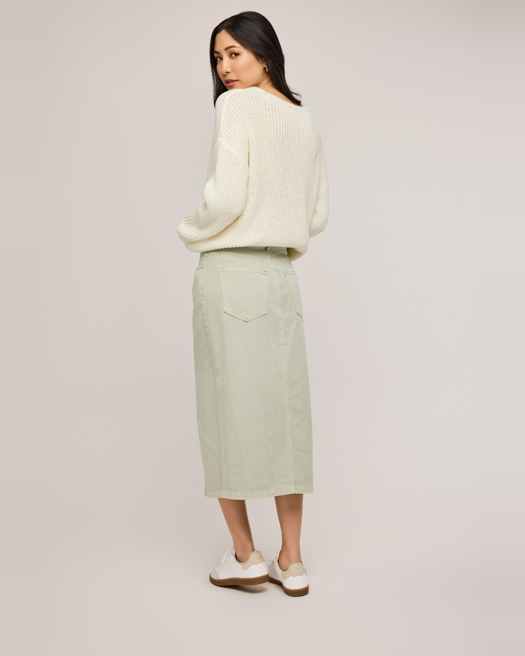 Back view of the sage green Georgia denim midi skirt showing the back pockets