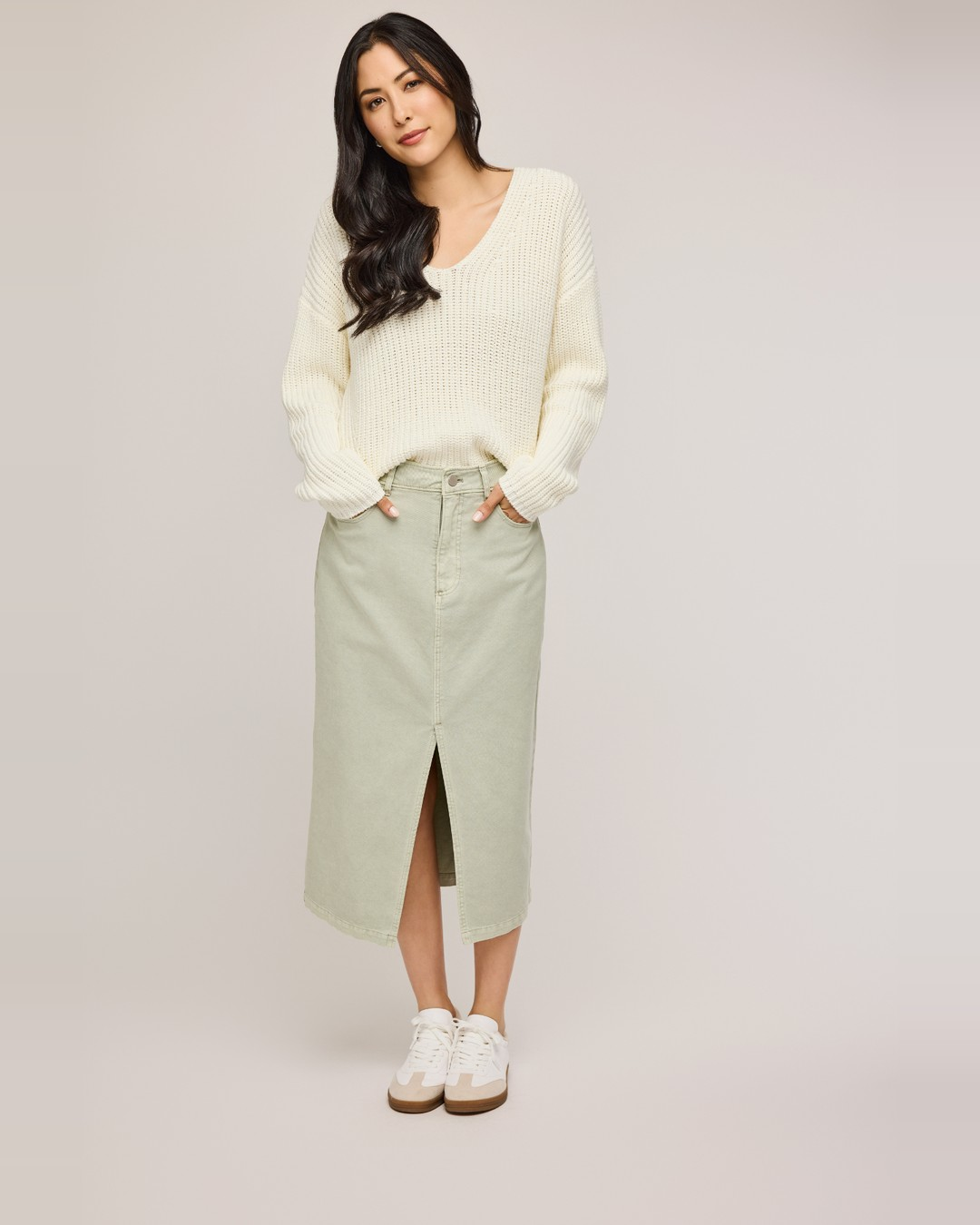 Gentle Fawn Georgia denim midi skirt in sage green with front slit, styled with a cream sweater and sneakers