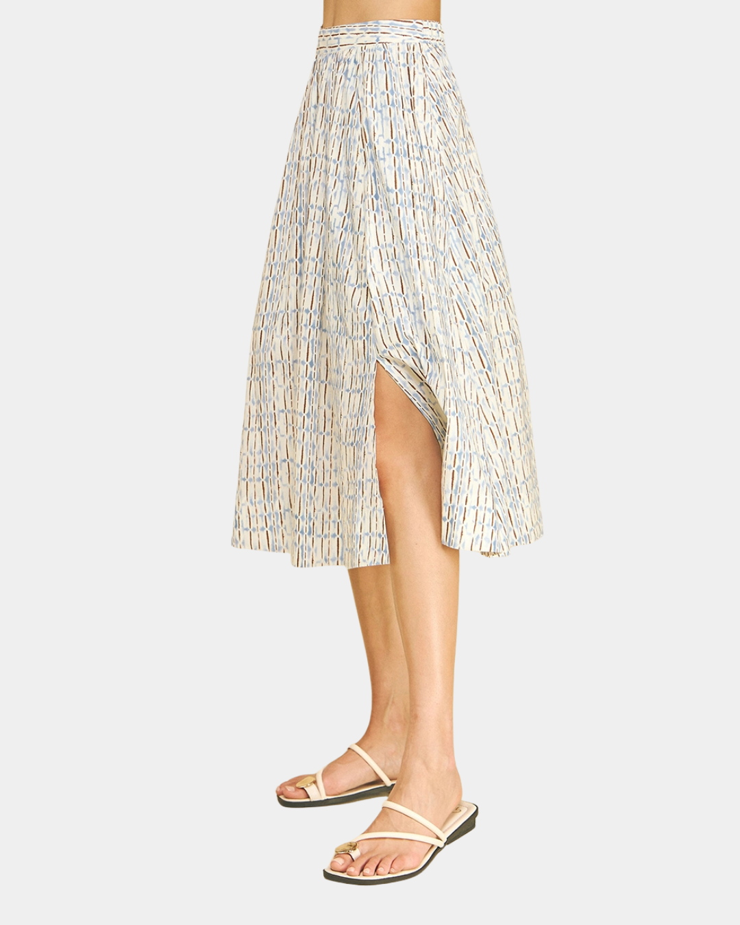 Side view of the Azure Horizon Midi Skirt featuring a soft blue and ivory print, elegant flowy silhouette, and front slit detail.