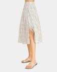 Side view of the Azure Horizon Midi Skirt featuring a soft blue and ivory print, elegant flowy silhouette, and front slit detail.