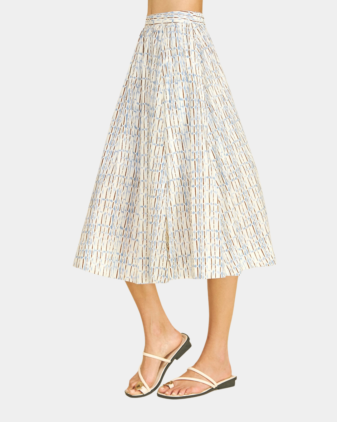 Side view of the Azure Horizon Midi Skirt showcasing the soft blue and ivory print, flattering midi-length silhouette, and lightweight woven fabric.