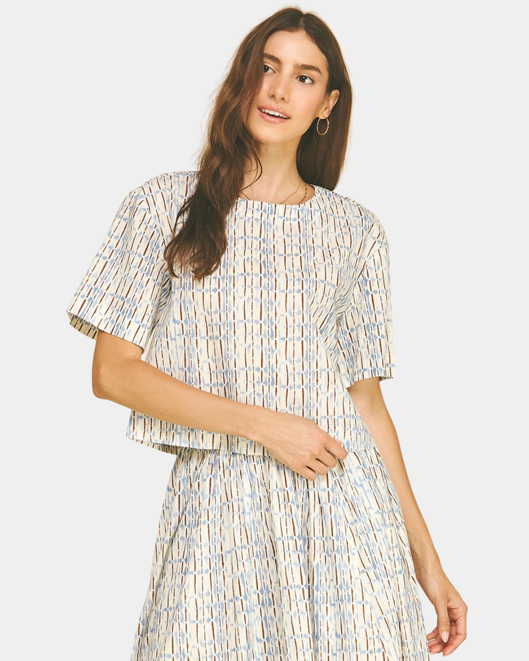 Close-up of the Azure Horizon Top highlighting the soft blue and ivory print, clean neckline, and short sleeve design.