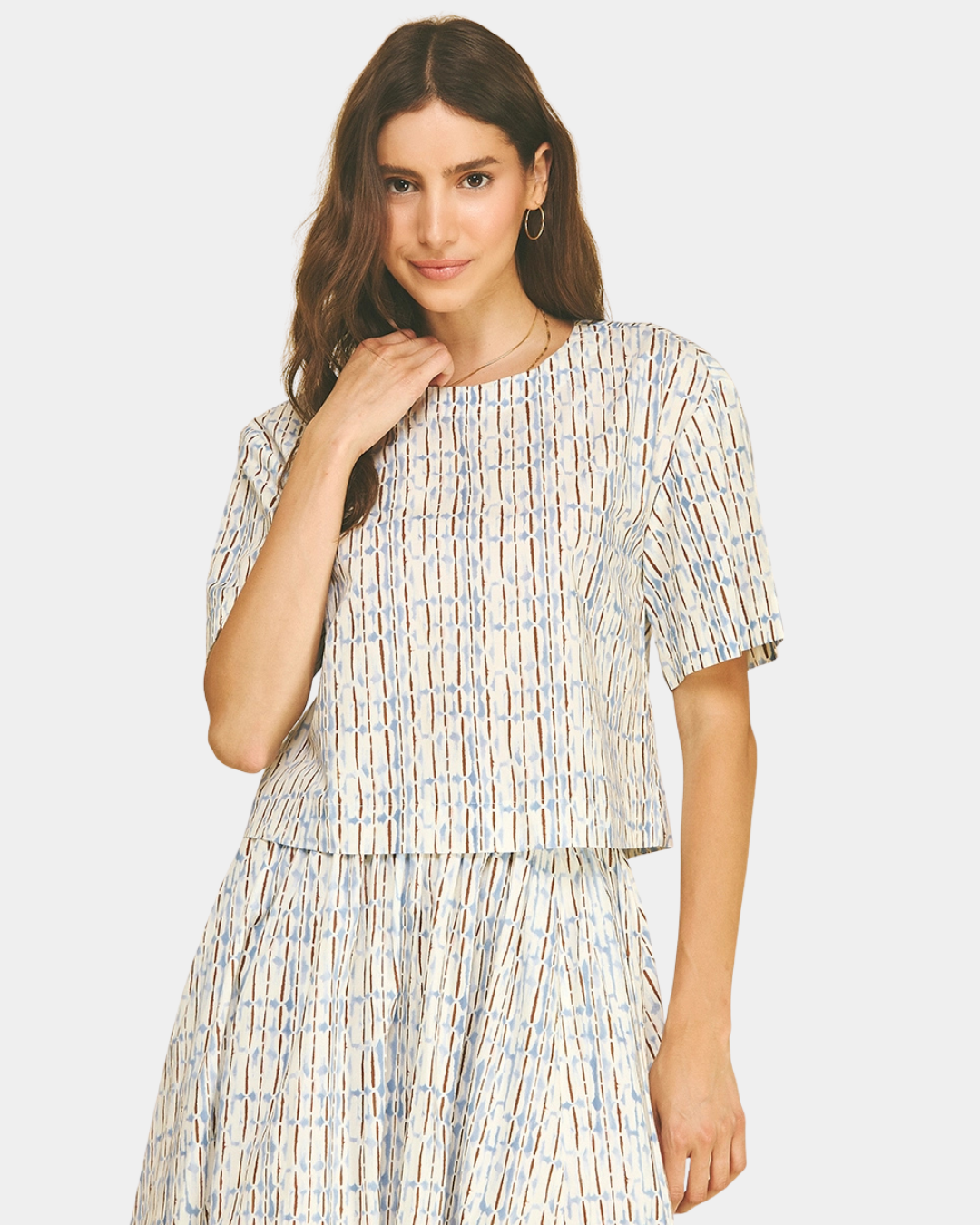 Front view of the Azure Horizon Top featuring a soft blue and ivory print, short sleeves, and a modern cropped silhouette.