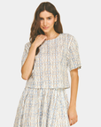 Front view of the Azure Horizon Top featuring a soft blue and ivory print, short sleeves, and a modern cropped silhouette.