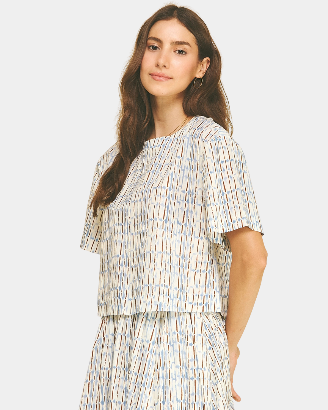 Side view of the Azure Horizon Top showcasing the soft blue and ivory print, relaxed fit, and contemporary cropped design.